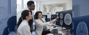 Diverse neonatal neuroscience team examining brain MRI data in a clinical research environment.